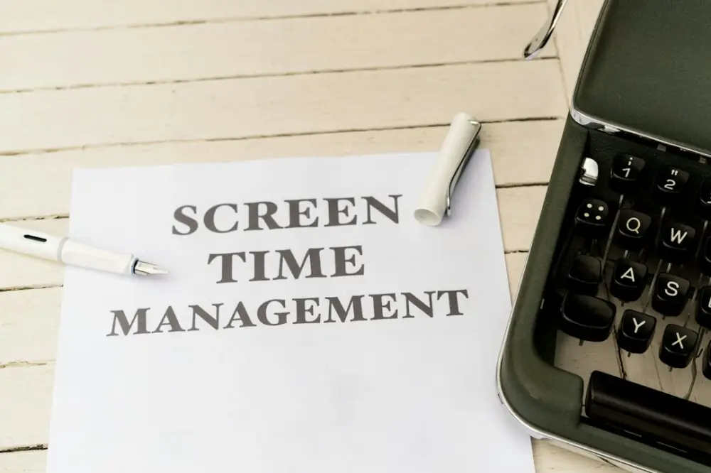a piece of paper that says screen time management next to a typewriter